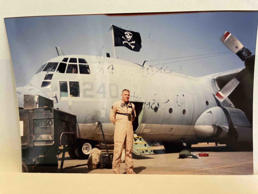 A Marine KC-130 Navigator in front of the aircraft he is going to navigate into combat.